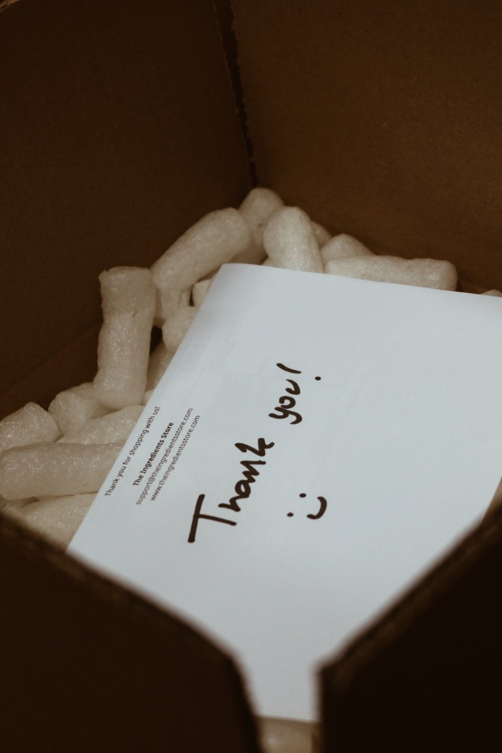 A handwritten thank-you note in a packed order
